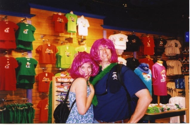couple wearing pink wigs in store