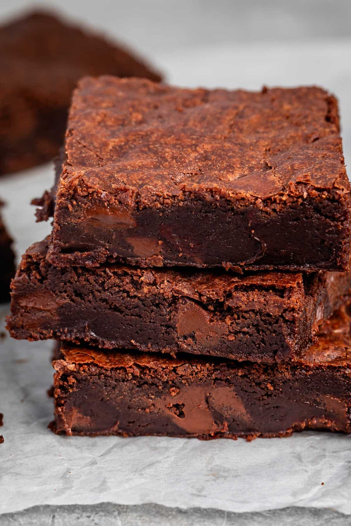 stacked brownies with chocolate chips baked in on the inside.