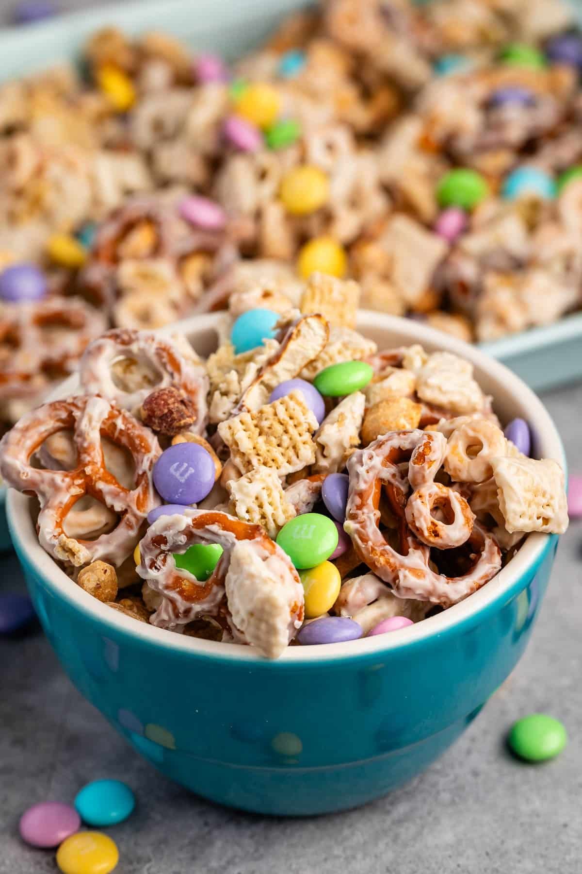 bunny munch mixed in a teal bowl with white chocolate.