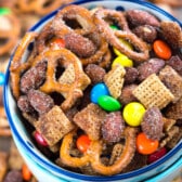 bowl of snack mix with pretzels and m&ms.