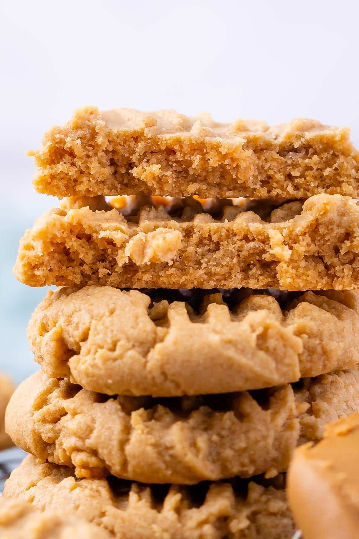 stack of 3 peanut butter cookies with close up of 2 halves