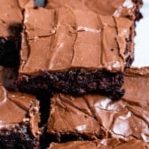 brownie with chocolate frosting sitting on other brownies with words on the photo